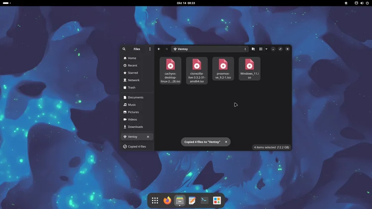 The file manager showing the Ventoy drive with four ISO files, cachyos, clonezilla, proxmox and Windows 11, and a message that 4 files were copied.
