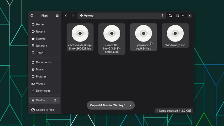 The file manager showing the Ventoy drive with four ISO files, cachyos, clonezilla, proxmox and Windows 11, and a message that 4 files were copied.