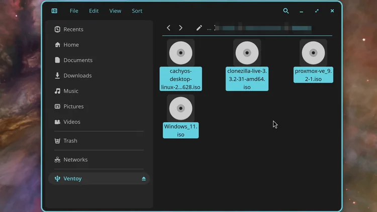 The file manager showing the Ventoy drive with four ISO files: cachyos, clonezilla, proxmox and Windows 11.