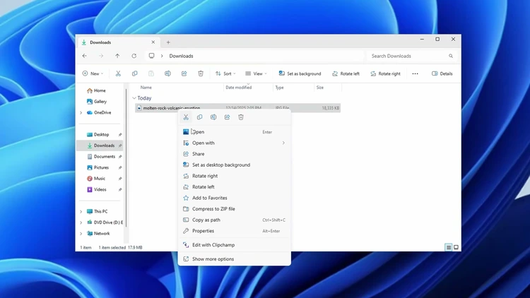Right-clicking a downloaded image file in File Explorer and selecting Set as desktop background from the context menu.